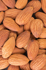 Almond textured background closeup. Organic food rustic. Tasty healthy snack. Top view