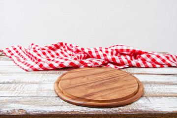 Top view wrinkled red tablecloth and plank on wooden table, mock up