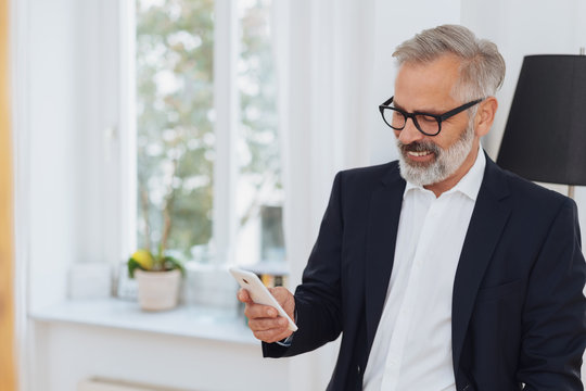 Smart businessman reading a mobile phone message