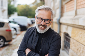 Attractive bearded man leaning forwards laughing