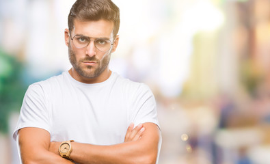 Young handsome man wearing glasses over isolated background skeptic and nervous, disapproving...