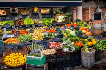 Obraz na płótnie Canvas Variety of beautifully organized fruits and vegetables on the counter of the market place