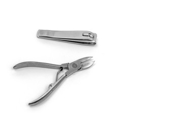 On a white background manicure and pedicure tools. Two nail clippers.