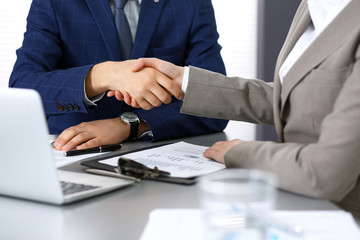 Business people shaking hands, finishing up a meeting. Papers signing, agreement and lawyer consulting concept