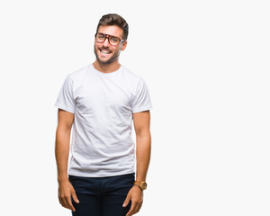 Young handsome man wearing glasses over isolated background looking away to side with smile on face, natural expression. Laughing confident.