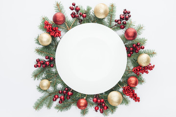 top view of pine tree wreath with Christmas decorations and round blank space in middle isolated on...