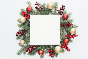 top view of pine tree wreath with Christmas decorations and square blank space in middle isolated...