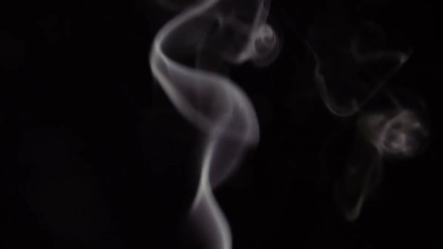 White Steam Rises from up. White smoke over a black background. Smoke slowly floating through space against black background. Slow Motion.