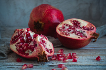 Pomegranate and pomegranate seeds on a wooden table