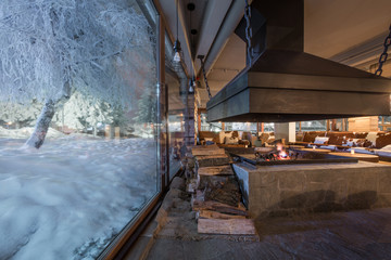 Fototapeta na wymiar Big window in winter night and restaurant interior