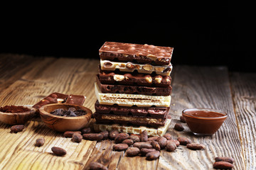 Chocolate bars on table with chocolate tower.