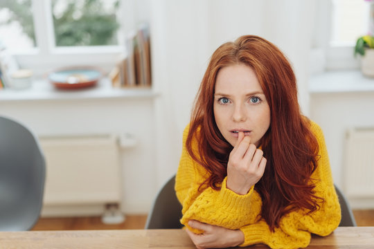Thoughtful intense young redhead woman