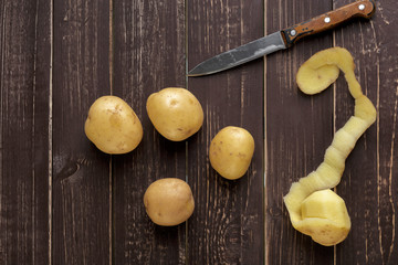 Fresh potatoes on the wood background