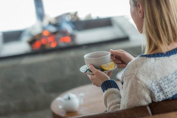 Blonde woman drinking tea in relaxing restaurant