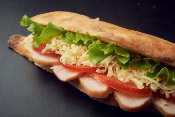 Ciabatta sandwiche with pickles, cheese, tomatoes, ham and lettuce