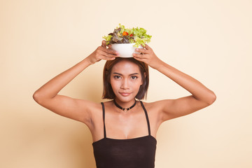 Healthy Asian woman with salad.