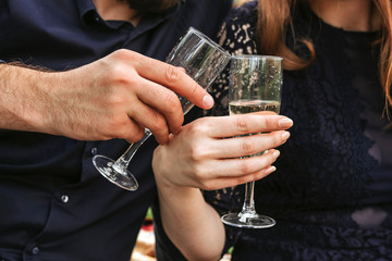 Men's and women's hands with glasses of champagne