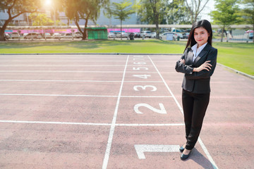 Obraz premium Business competition: businesswoman is the winner on number 1 at start line