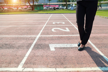 Business competition: businesswoman is the winner on number 1 at start line
