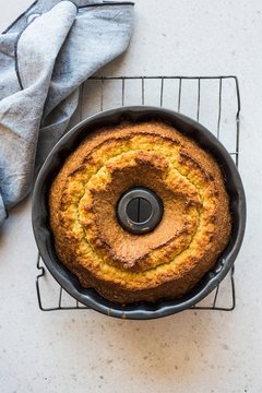 Overhead view of olive oil bundt cake in baking tin