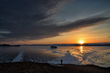 Frozen Lake Baikal. Beautiful stratus clouds over the ice surface on a frosty day.