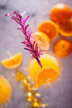 Overhead view of apricot cocktail garnish with orange slice