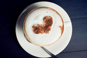 Top view of hot coffee latte or cappuccino art heart shape foam