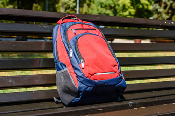 Tourist backpack on a bench in city park