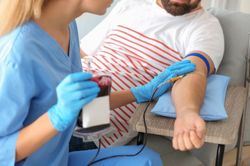Man donating blood in hospital