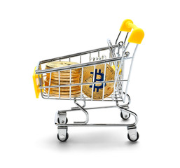 Shopping cart with bitcoins on white background