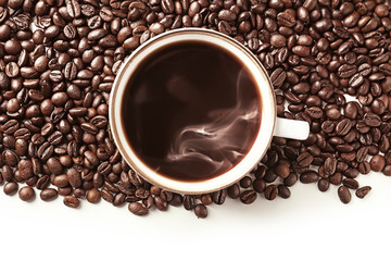 Cup of coffee and roasted beans on white background