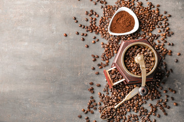 Composition with coffee grinder and beans on grey background