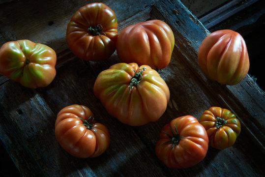 Organic tomatoes on wooden table