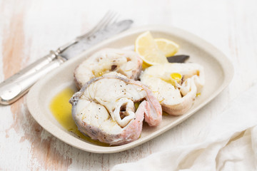 Fototapeta na wymiar boiled fish with lemon and olive oil