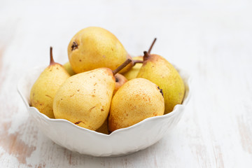 fresh yellow pears on white dish