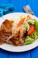 roasted pork with boiled rice and salad on white plate