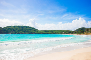 Fototapeta na wymiar Idyllic tropical beach with white sand, turquoise ocean water and blue sky on Caribbean island