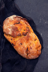 cornbread with chourico on black ceramic background
