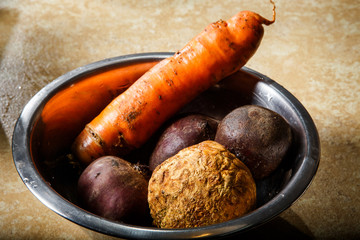 raw vegetables in metal bowl