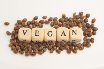 Alphabet cubes with cannabis seeds on white background vegan