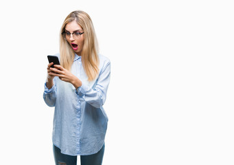 Young beautiful blonde business woman using smartphone over isolated background scared in shock with a surprise face, afraid and excited with fear expression
