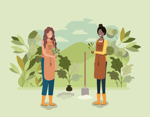 Obraz na płótnie Canvas girls planting trees in the park