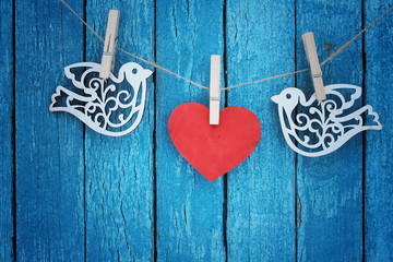 love / valentines day card with wooden heart and birds/blue background /copy space
