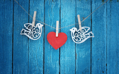 love / valentines day card with wooden heart and birds/blue background /copy space