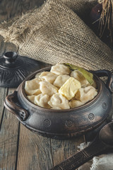 pelmeni Russian national Ukrainian dish in a clay pot
