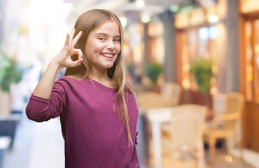 Young beautiful girl over isolated background smiling positive doing ok sign with hand and fingers. Successful expression.