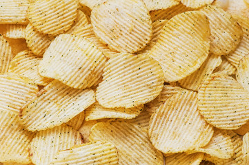 Potato chips corrugated background top view, close-up