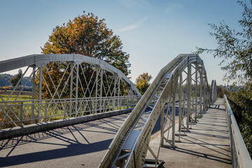 old metal bridge with railing and shadows