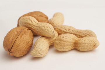 Peanuts and walnuts on white background macro