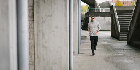 Sporty man running in autumn